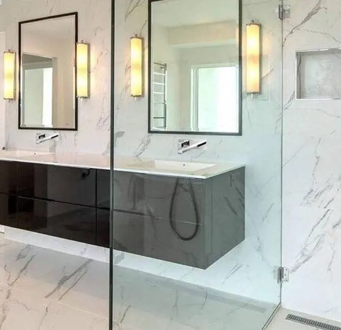 A bathroom with two mirrors and a sink.