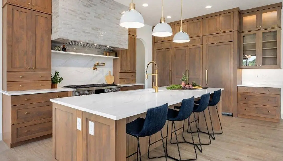 A kitchen with wooden cabinets and blue chairs