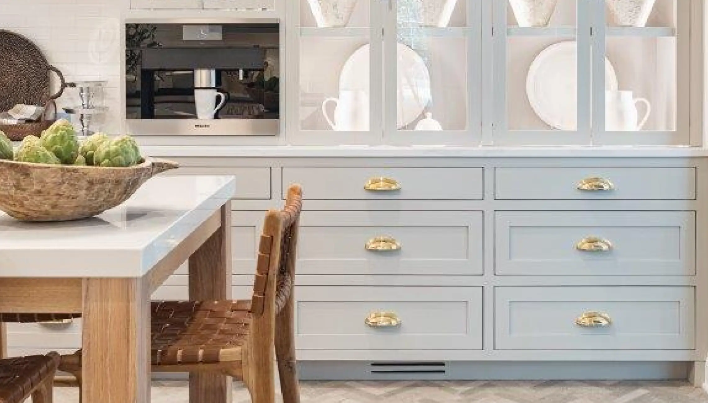 A kitchen with white cabinets and a table