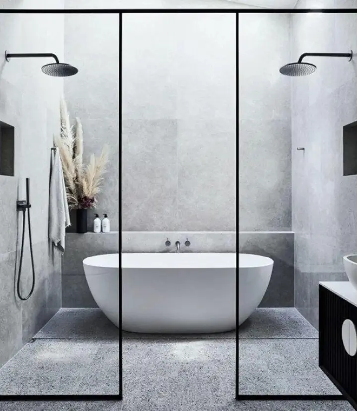 A bathroom with two shower heads and a bathtub.