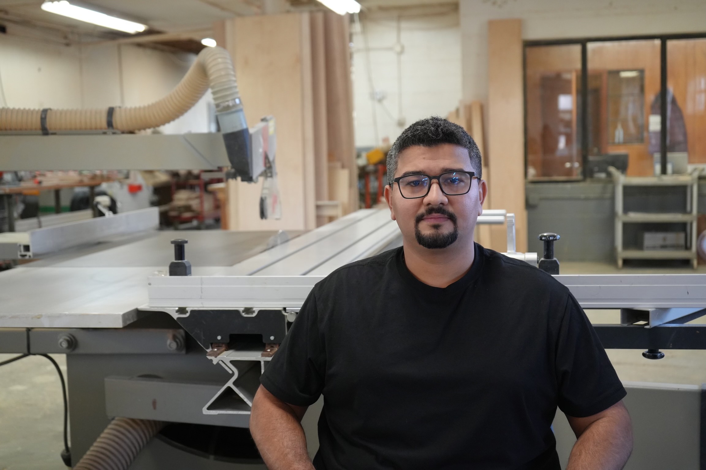 A man standing in front of a table with a machine.