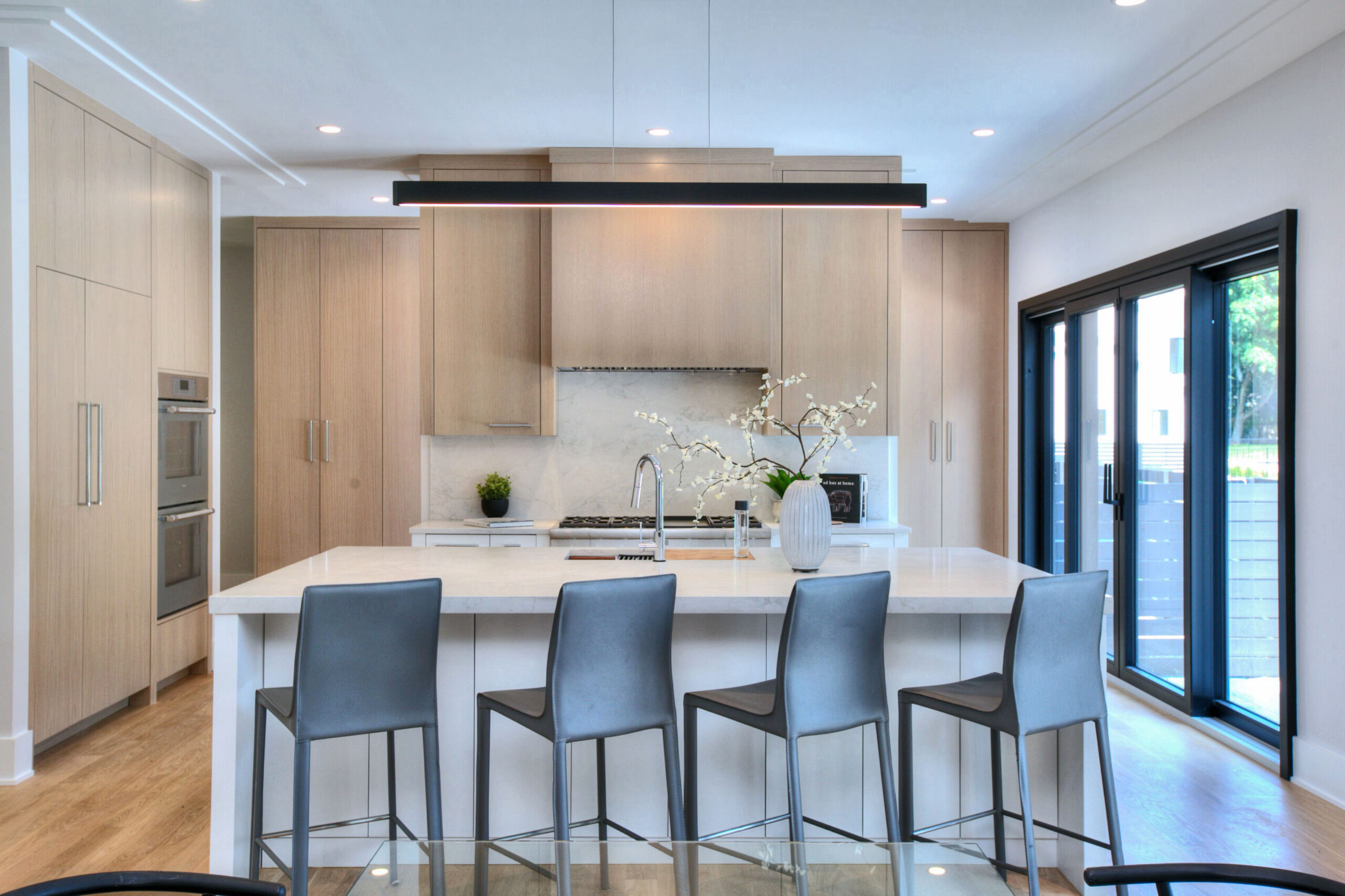 A kitchen with four chairs and a counter