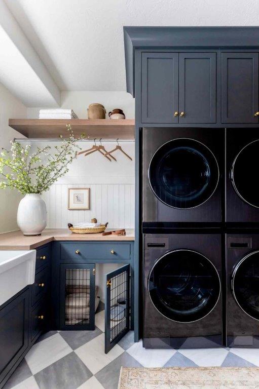 A kitchen with black cabinets and a sink